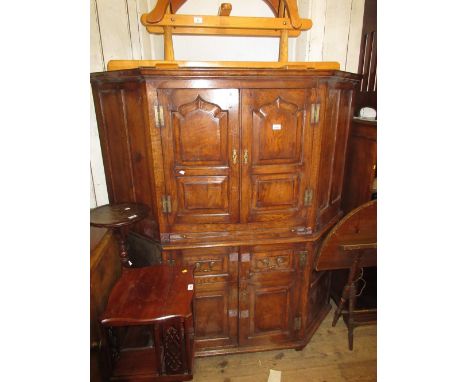 Reproduction oak corner cocktail cabinet, the moulded cornice above a pair of arched panel doors, the base with two drawers a