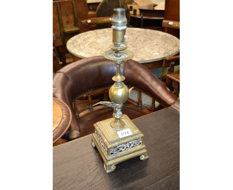 Late 19th / early 20th Century cast brass lamp base, the finial in the form of an eagle holding a ball on square base