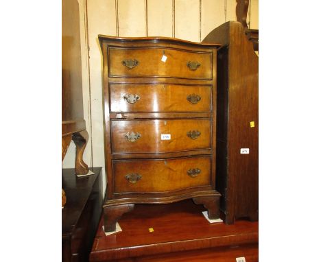 Reproduction walnut and crossbanded small serpentine chest of four drawers on bracket feet