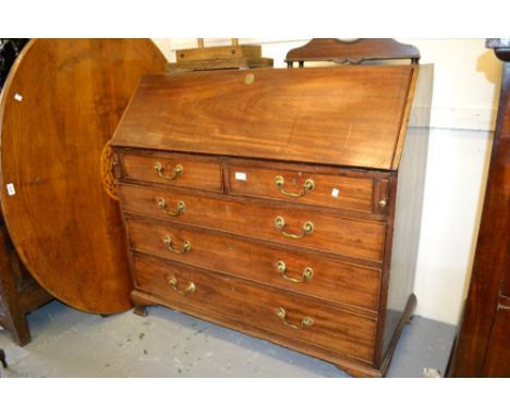 George III mahogany bureau, the fall front enclosing a well fitted interior with marquetry inlaid door and drawers above two 