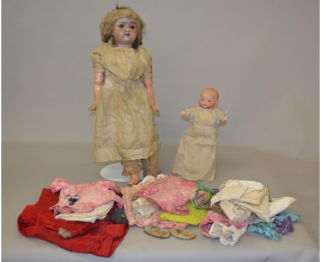 Porcelain headed doll with composition jointed body, marked 1909 DEP R6A,56cm, together with a small baby doll no marks, bisq