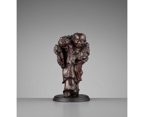   A BURLWOOD CARVING OF LIU HAI, LATE MING TO EARLY QING  China, 17th-18th century. Carved in a standing position, using the 