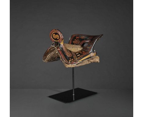   A LACQUERED WOOD SADDLE, QING DYNASTY  South China, Yunnan Province, 19th century. The wood lacquered black, crimson red an