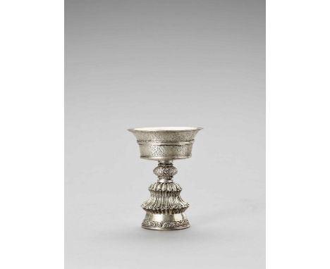   A LARGE SILVER BUTTER LAMP  Tibet, late 19th century. Of fine silver repoussé, the bowl with flared sides rising to the wid