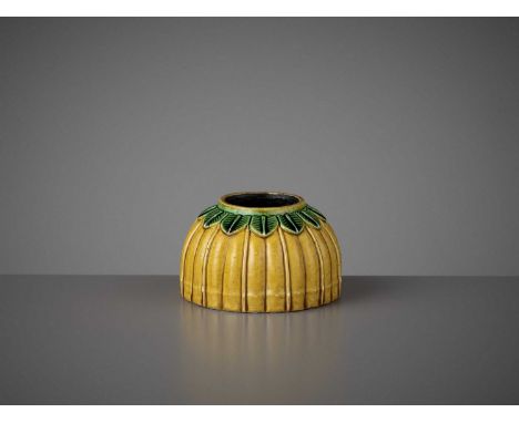   AN IMPERIAL YELLOW BISCUIT WASHER, KANGXI  China, 1662-1722. Superbly modeled in the shape of an upturned lotus bud with a 