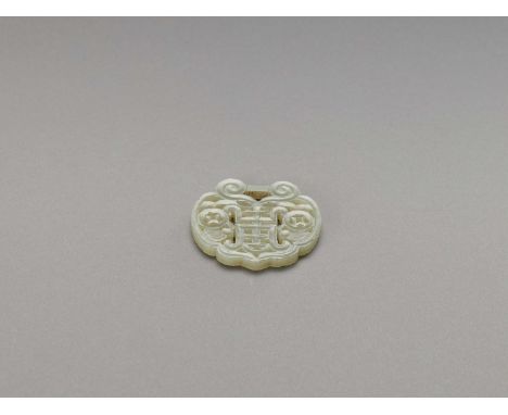   A CELADON JADE ‘SHOU’ PENDANT, QING  China, 1644-1912. The translucent stone of celadon tone, carved and pierced as a lock 