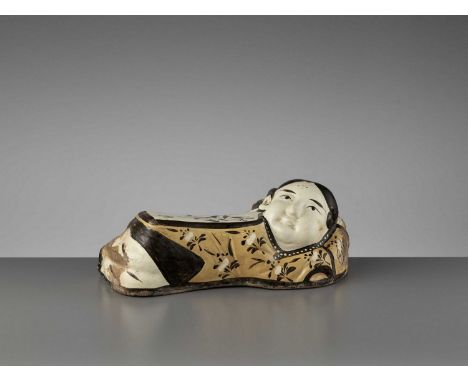   A PAINTED CIZHOU ‘SLEEPING LADY’ PILLOW, JIN DYNASTY  China, 1115-1234. Modeled in the form of a sleeping girl, covered wit