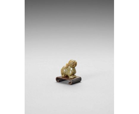   A JADE CARVING OF A BIXIE  China, Ming dynasty (15th-16th century). The mythical beast carved from a light olive-green jade
