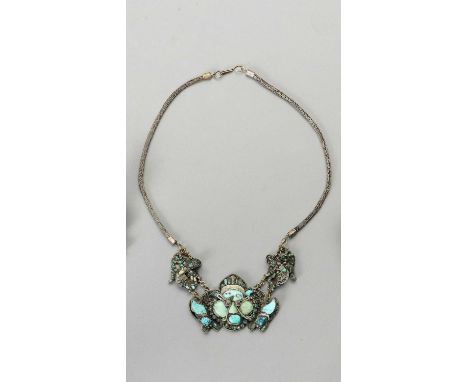   A SILVER-PLATED METAL AND TURQUOISE NECKLACE  Tibet, c. 1900 – 1920. The pendant consisting of three parts connected with h