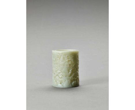   A CELADON JADE BRUSH POT, BITONG, QING  China, 1644-1912. Of cylindrical form, finely carved in openwork with pines and oth