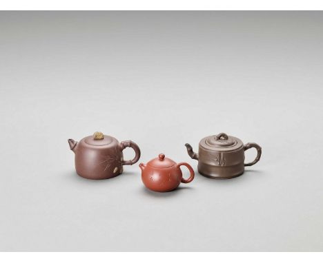  THREE YIXING TEAPOTS AND COVERS, LATE QING TO REPUBLIC  China, 1900-1950. One teapot of cylindrical form, the cover with ba