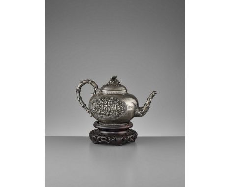   A FINE SILVER TEAPOT, QING DYNASTY  China, 19th century. The sides embossed and engraved with two lobed medallions and mani