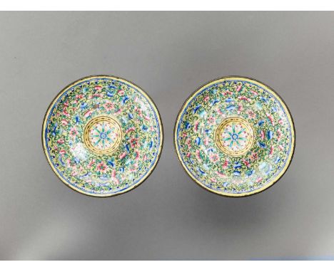   A PAIR OF CANTON ENAMEL CUP STANDS, QING  China, 1850-1900. Painted in polychrome enamels with flowers and peaches on scrol