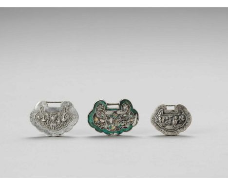   TWO SILVER AND ONE SILVERED METAL LOCK CHARM, LATE QING  China, late Qing dynasty (1644-1912), 19th century. Of silvered me