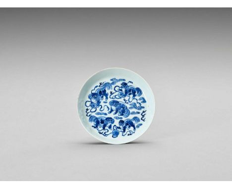   BLUE AND WHITE PORCELAIN DISH WITH PEKINGESE DOGS  China, Qing Dynasty (1644-1912). The plate with shallow rounded sides. T