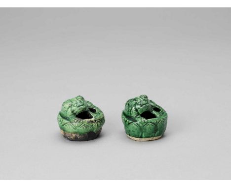   A PAIR OF EMERALD GREEN GLAZED POTTERY BUDDHIST LION WATER DROPPERS, KANGXI  China, 1661-1722. The Buddhist lions finely in