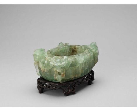   A CHRYSOPRASE ‘BOYS AND LOTUS’ BASIN, QING  China, 1644-1912. The translucent stone of an appealing color ranging from appl