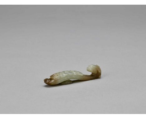   A DEEP CELADON AND RUSSET JADE ‘DRAGON’ BELT HOOK, QING  China, 19th century. The pierced top is carved with flowers and sc