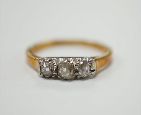 An 18ct, plat. and three stone diamond set ring, size K/L, gross weight 2.5 grams.