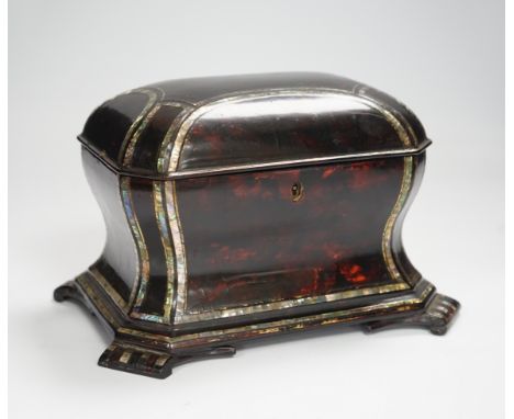 A Victorian papier mache tea caddy, stamped Jennens and Bettridge, in the form of a sarcophagus with inset mother of pearl ba