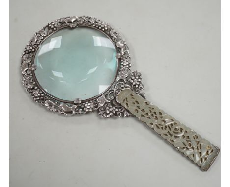 A Chinese white metal and pale celadon jade handled magnifying glass, early 20th century, stamped ‘SILVER’, 19cm long