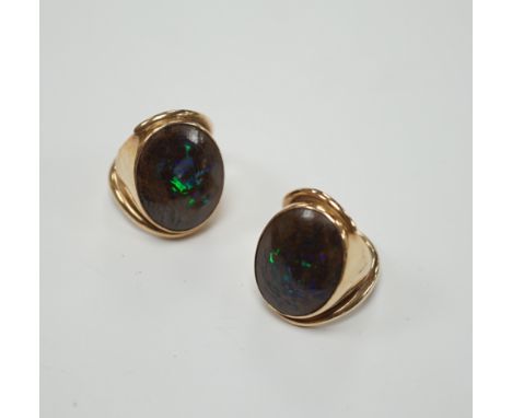 A pair of yellow metal and oval boulder opal set dress rings, both size M, gross weight 20 grams.