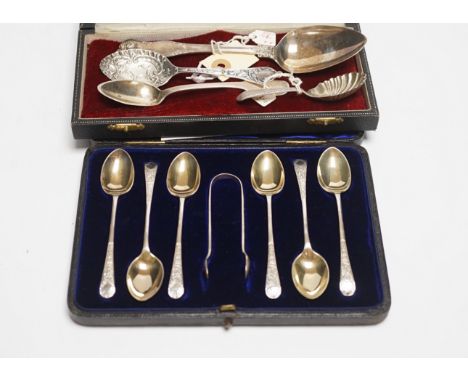 A cased set of six silver teaspoons and tongs and four other assorted silver or white metal spoons, including a caddy spoon.