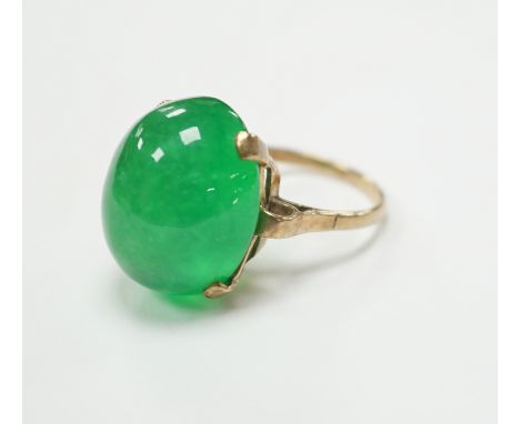 A 9ct and large cabochon oval jade set ring, size P/Q, gross weight 11.6 grams, the stone measuring approx. 21.1mm by 17.4mm,