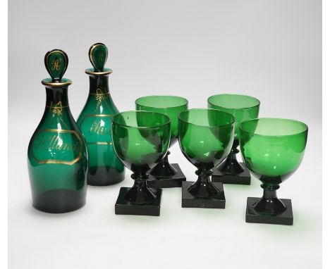 A pair of small Bristol green decanters, Rum and Hollands, c.1800 and five 19th century green glass rummers, with lemon squee