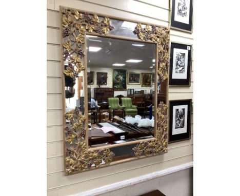 A rectangular marginal plate bevelled wall mirror, the part painted frame carved with grapes and vine leaves, width 86cm, hei
