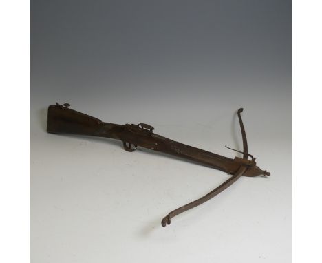 An antique probably late 18th/early 19th century Crossbow, with wooden stock and textured grip, steel trigger guard and fitti