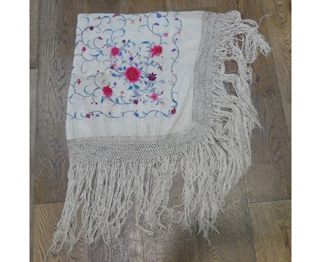 An early 20th century silk embroidered Cantonese Piano Shawl, the cream ground with bright flowers among scrolling foliage,&n