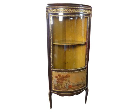 A French Louis XVI style bow-fronted corner display Cabinet, with gilt metal mounts depicting floral scrolls, above bowed doo