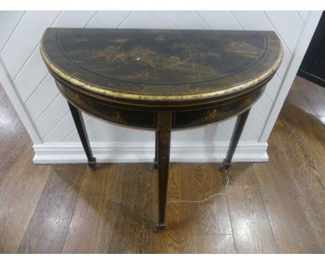 An early 20th century Chinoiserie demi lune&nbsp;card Table, black lacquered and painted gilt decorations, raised on tapering