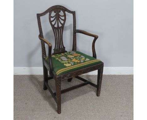A Georgian elbow Chair, with carved and pierced slat back and tapestry seat. 