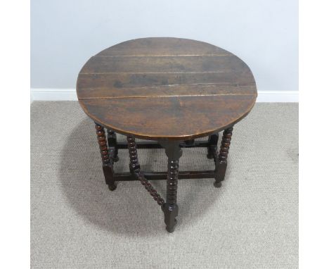 A small 18th century oak gateleg circular Table, raised on turned bobbin supports, W 99 cm x H 73 cm x D 87 cm. 