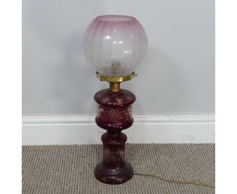 An antique ruby glass electrified Oil Lamp, with etched glass shade, H 49 cm, together with two brass Candlesticks, both elec