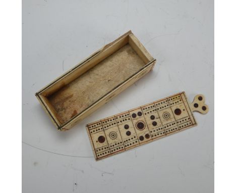An early 19th century French Prisoner of War carved bone Games Box, the sliding cover pierced for cribbage, note some damage 