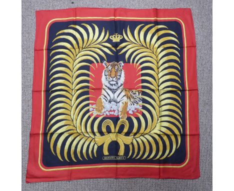 A Hermès&nbsp;silk twill scarf: Royal Tiger design, gold and black on red ground, hand rolled edges, two tiny thread pulls an