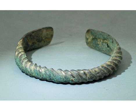 A lovely bronze bracelet from Luristan, ca. 800 - 200 BC. This beautiful braided example is 2-3/4- wide and has flared termin