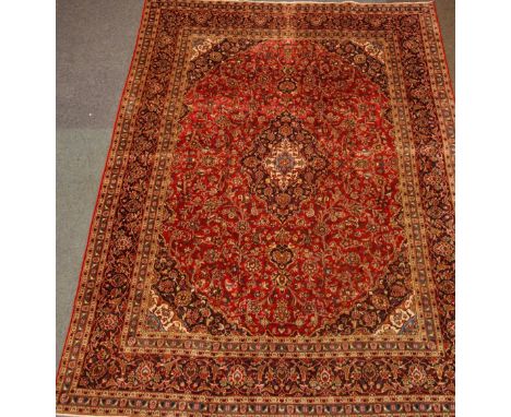 Large Persian Kashan red ground rug carpet, interlacing stylised floral field with medallion, repeated in boarder, 387cm x 27