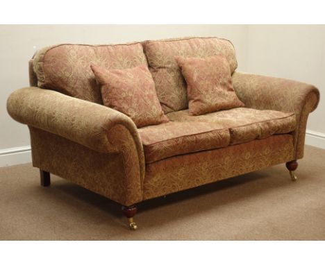 Traditional shaped two seat sofa upholstered in Nouveau type fabric, mahogany feet with brass castors, W175cm   Condition Rep