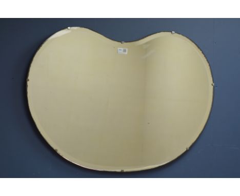 Early 20th century kidney shaped bevel edged frameless mirror, 77cm x 56cm   Condition Report   Click here for further images