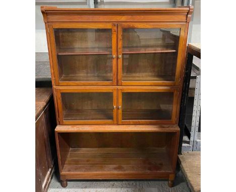 A 20th century mahogany bookcase, the glazed top section having a single adjustable shelf with open section below, 136cm high