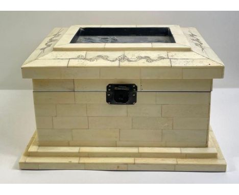 A 20th century bone casket, with brick panels throughout and portrait of a gentleman, 15cm high, 27cm long, 22cm wide