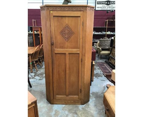 Good quality hand carved and panelled light oak corner wardrobe/ hall cupboard by Vernon Hale who carved the church furnishin