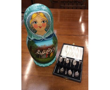 Six silver coffee spoons in case and Russian wooden doll set