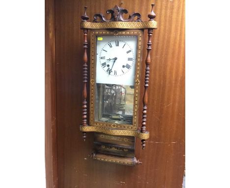 Victorian wall clock with square painted dial in a parquetry inlaid case with carved cresting and turned supports
