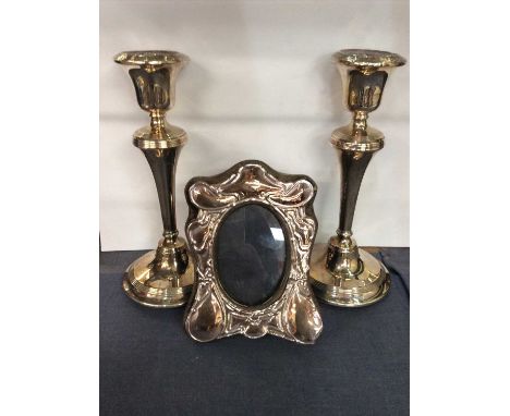 Pair of silver candlesticks and a silver photograph frame