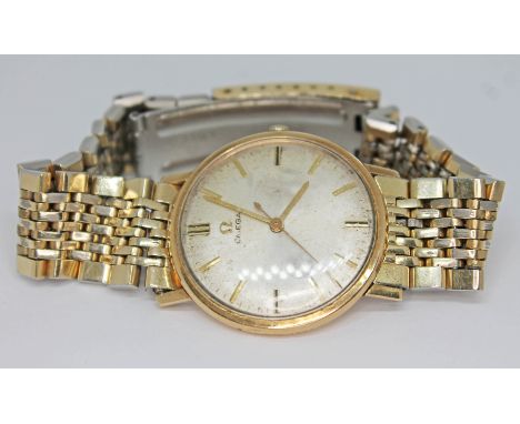 A vintage gold plated Omega manual wind wristwatch with signed dial, gold hands and hour markers on gold plated Omega bracele